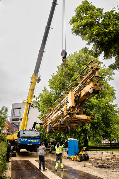 Liebherr's Mobile crane lifts construction crane over treetops